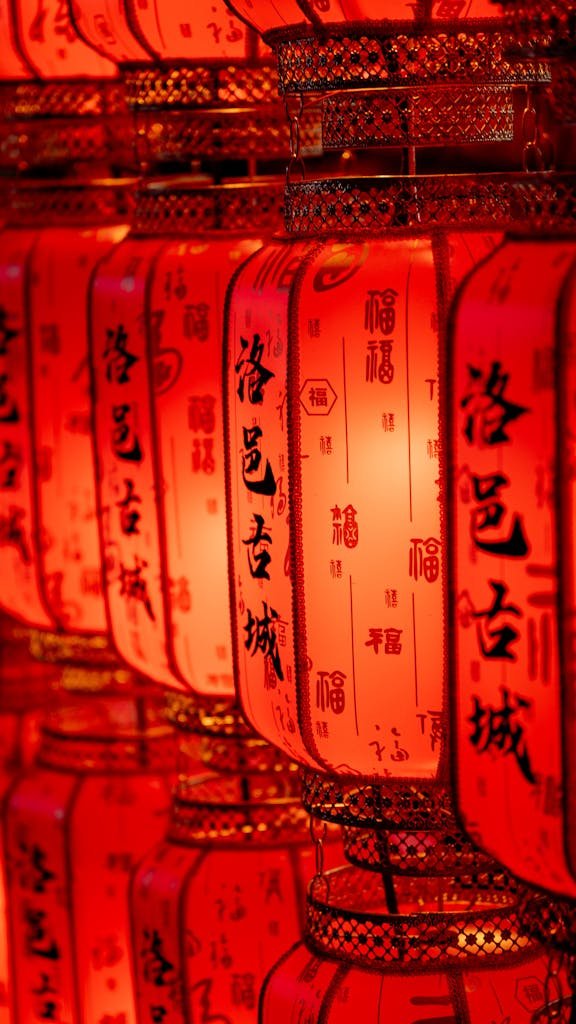 Close-up of traditional Chinese lanterns glowing warmly, symbolizing celebration and culture.
